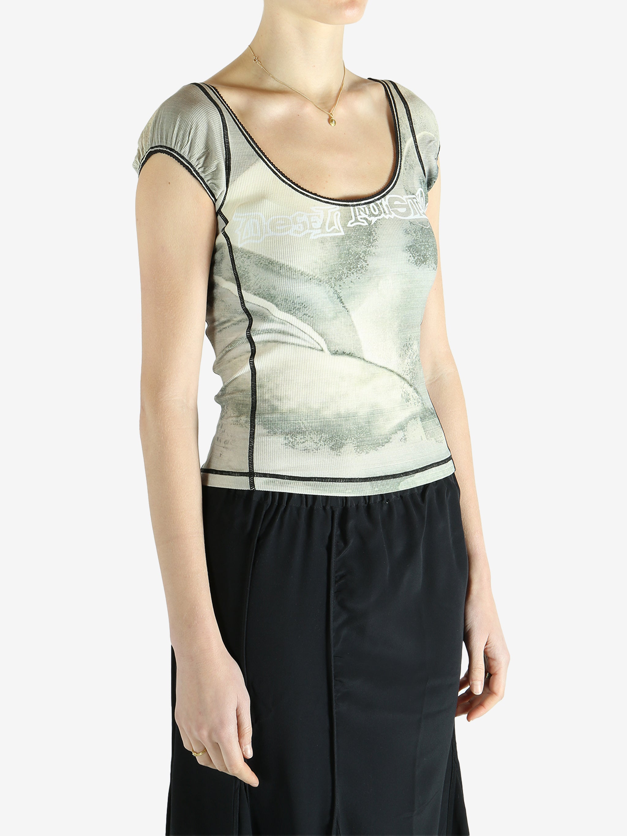 Green top worn by a person, showing the top's fit