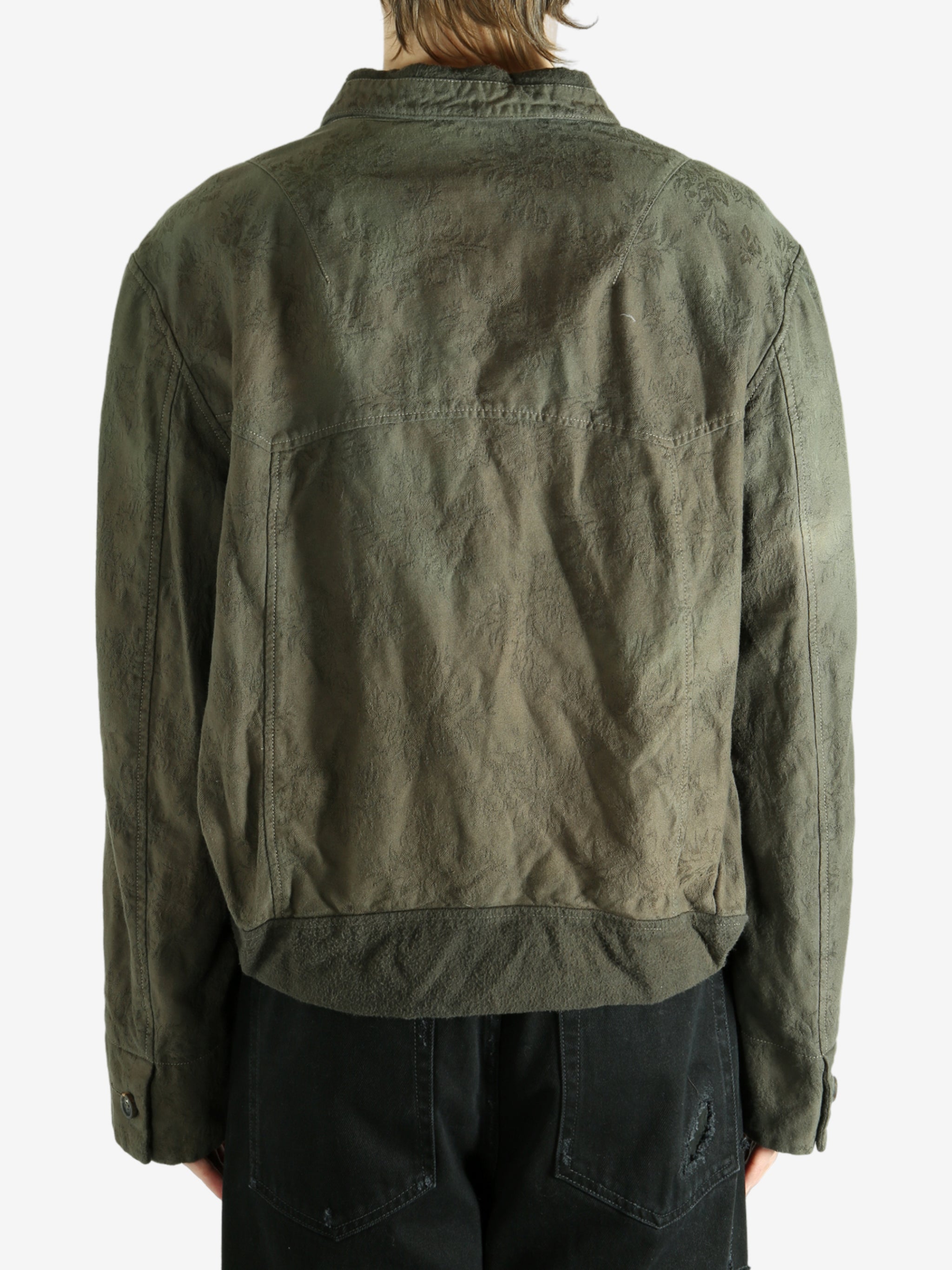 Green jacket worn by a person, showing the jacket's fit