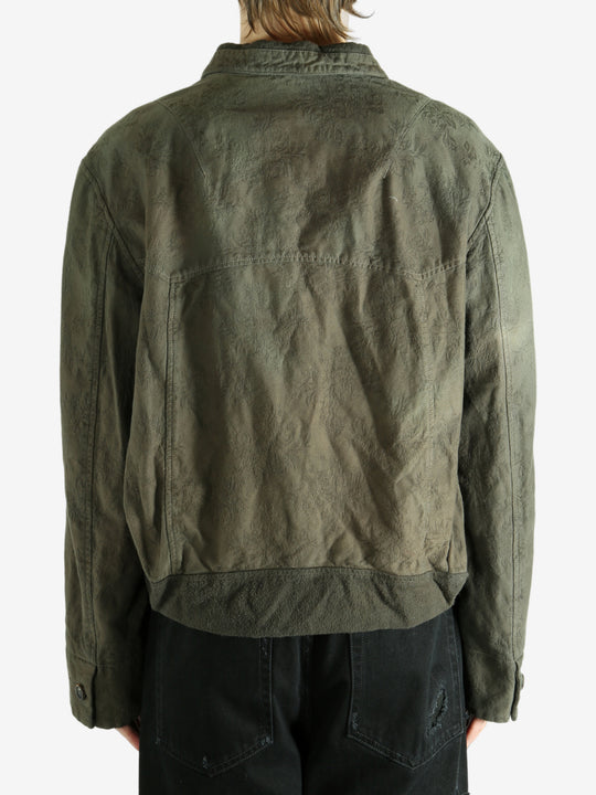 Green jacket worn by a person, showing the jacket's fit
