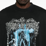 Close up of the black t-shirt, showing texture of the cotton fabric