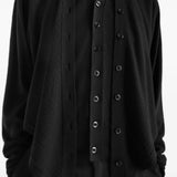 Black top worn by a person, showing the top fit