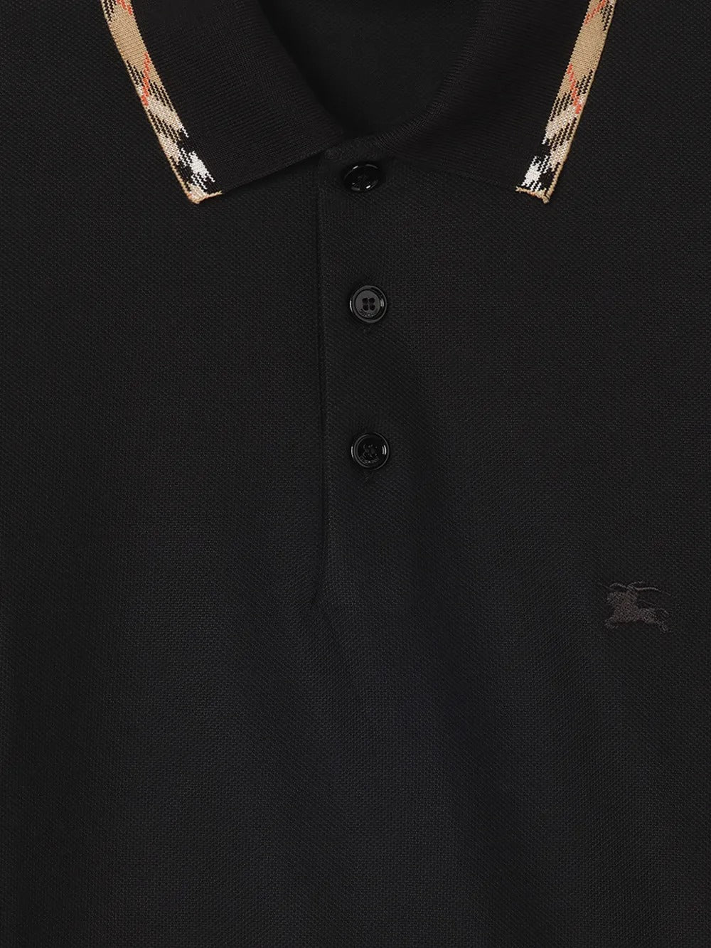 Close up of the black t-shirt, showing texture of the cotton fabric