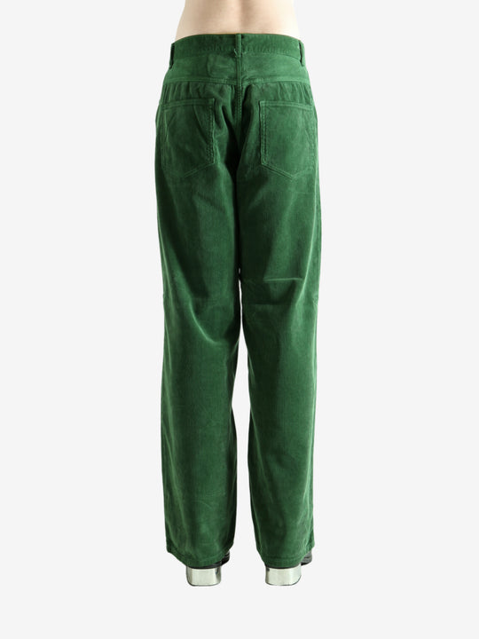 Green pants worn by a person, showing the pants's fit