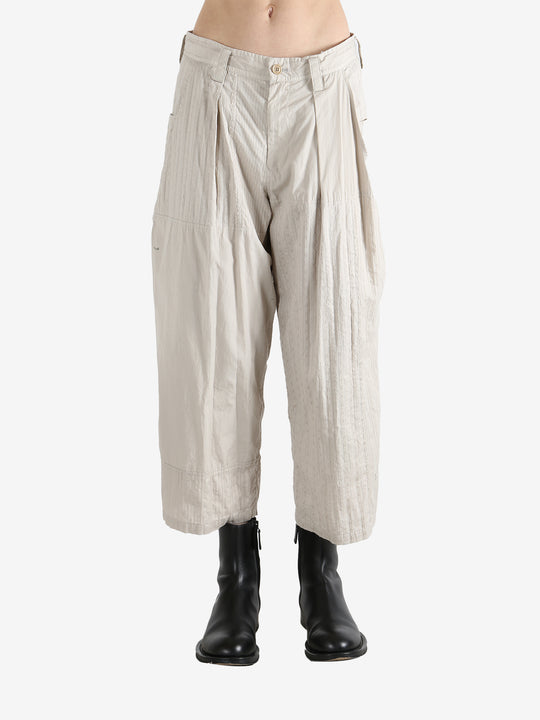 White pants worn by a person, showing the pants fit