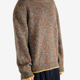 Brown knitwear worn by a person, showing the knitwear's fit