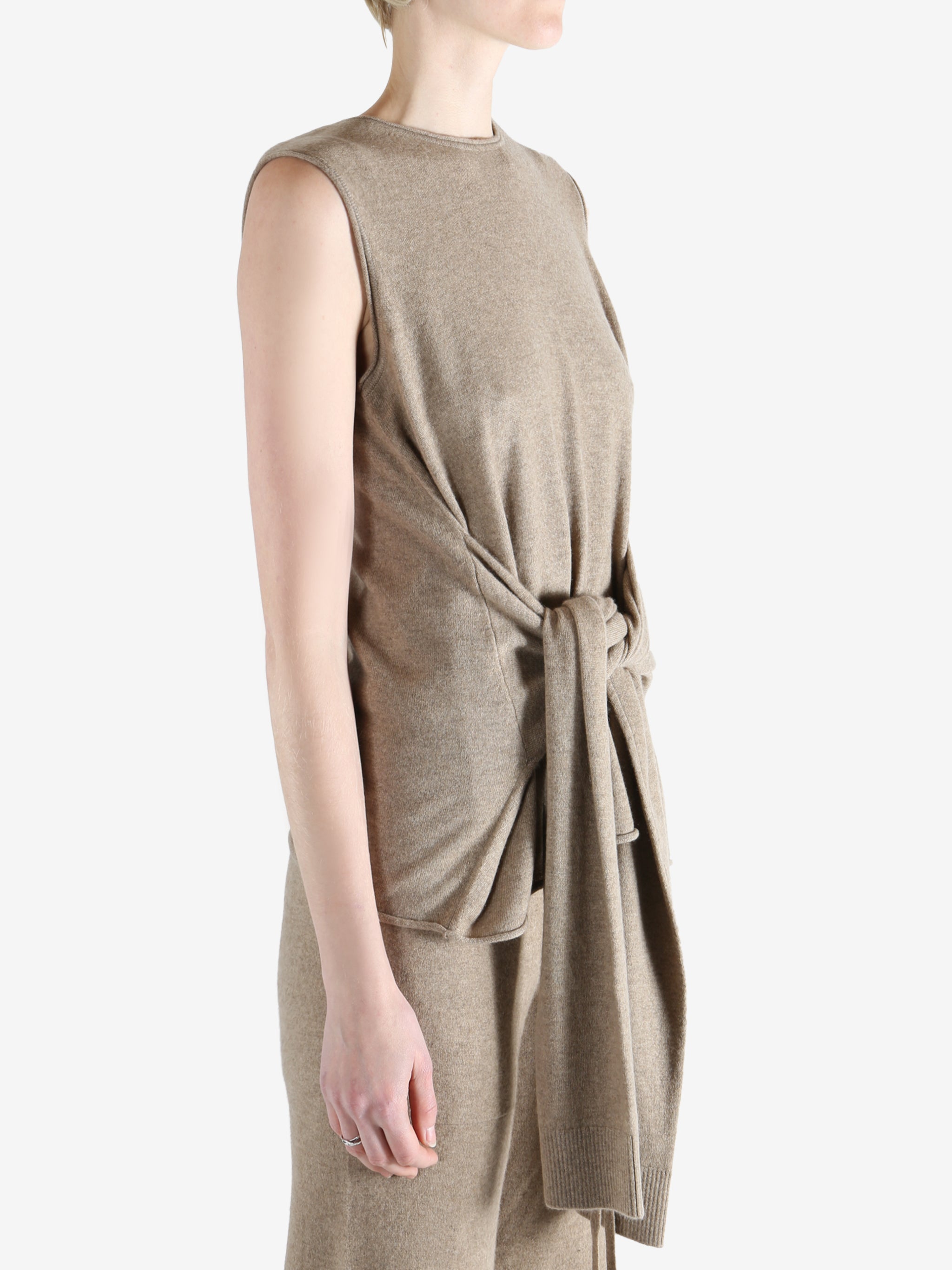 Beige top worn by a person, showing the top fit