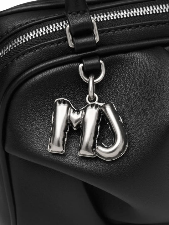 Close up of black bags, showing texture of the lamb leather fabric