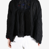 Black shirt worn by a person, showing the shirt fit