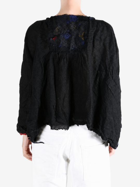 Black shirt worn by a person, showing the shirt fit