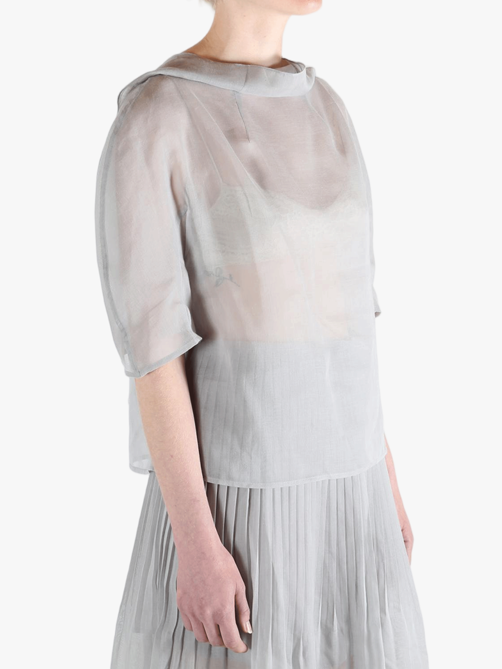 White top worn by a person, showing the top's fit