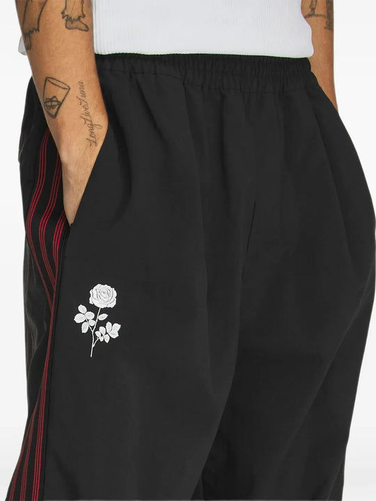Black pants worn by a person, showing the pants fit