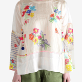 Tan top worn by a person, showing the top's fit