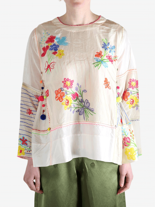 Tan top worn by a person, showing the top's fit