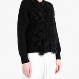 Black knitwear worn by a person, showing the knitwear fit