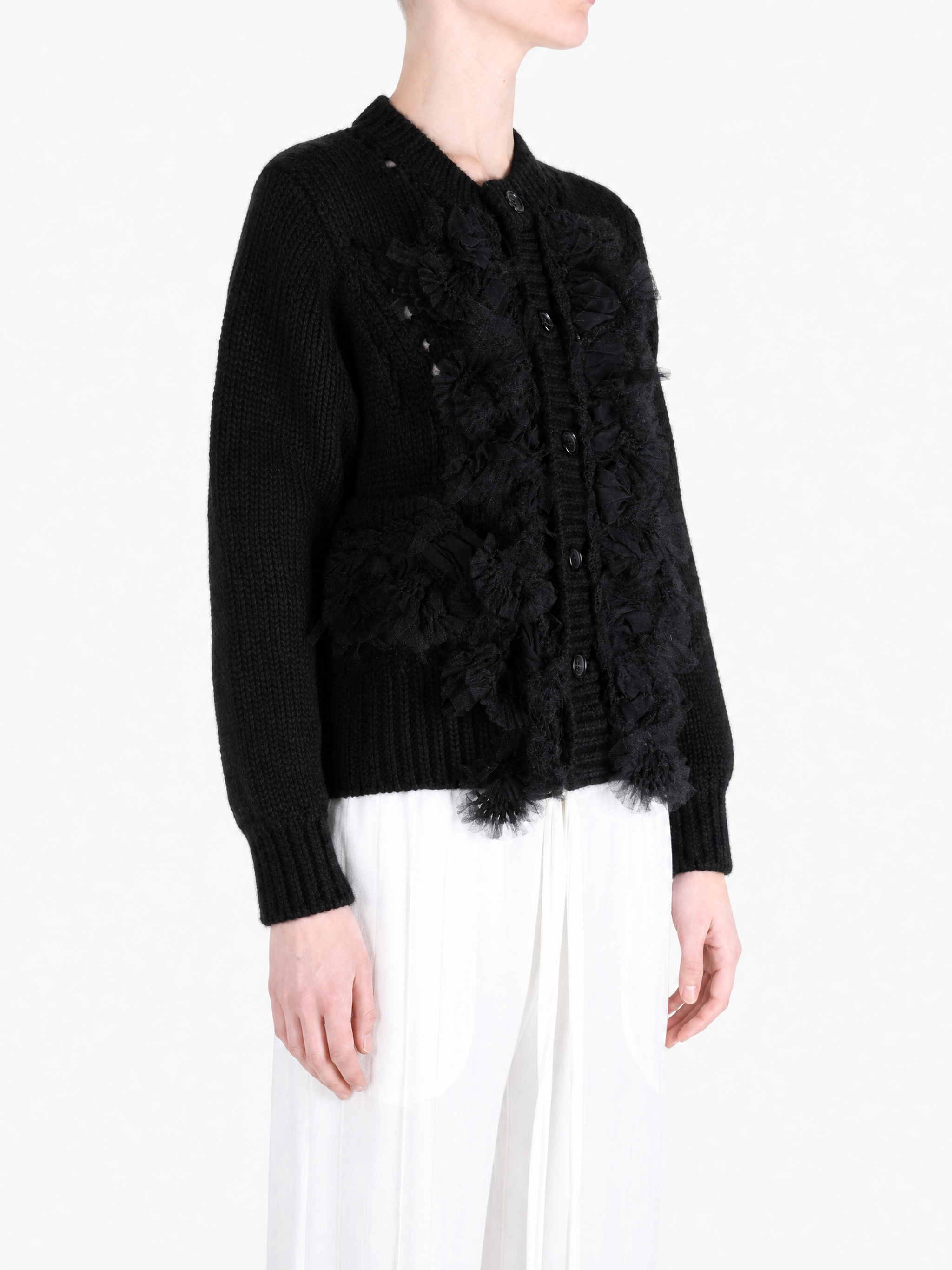 Black knitwear worn by a person, showing the knitwear fit