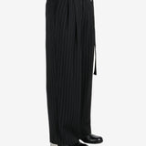 Black pants worn by a person, showing the pants fit