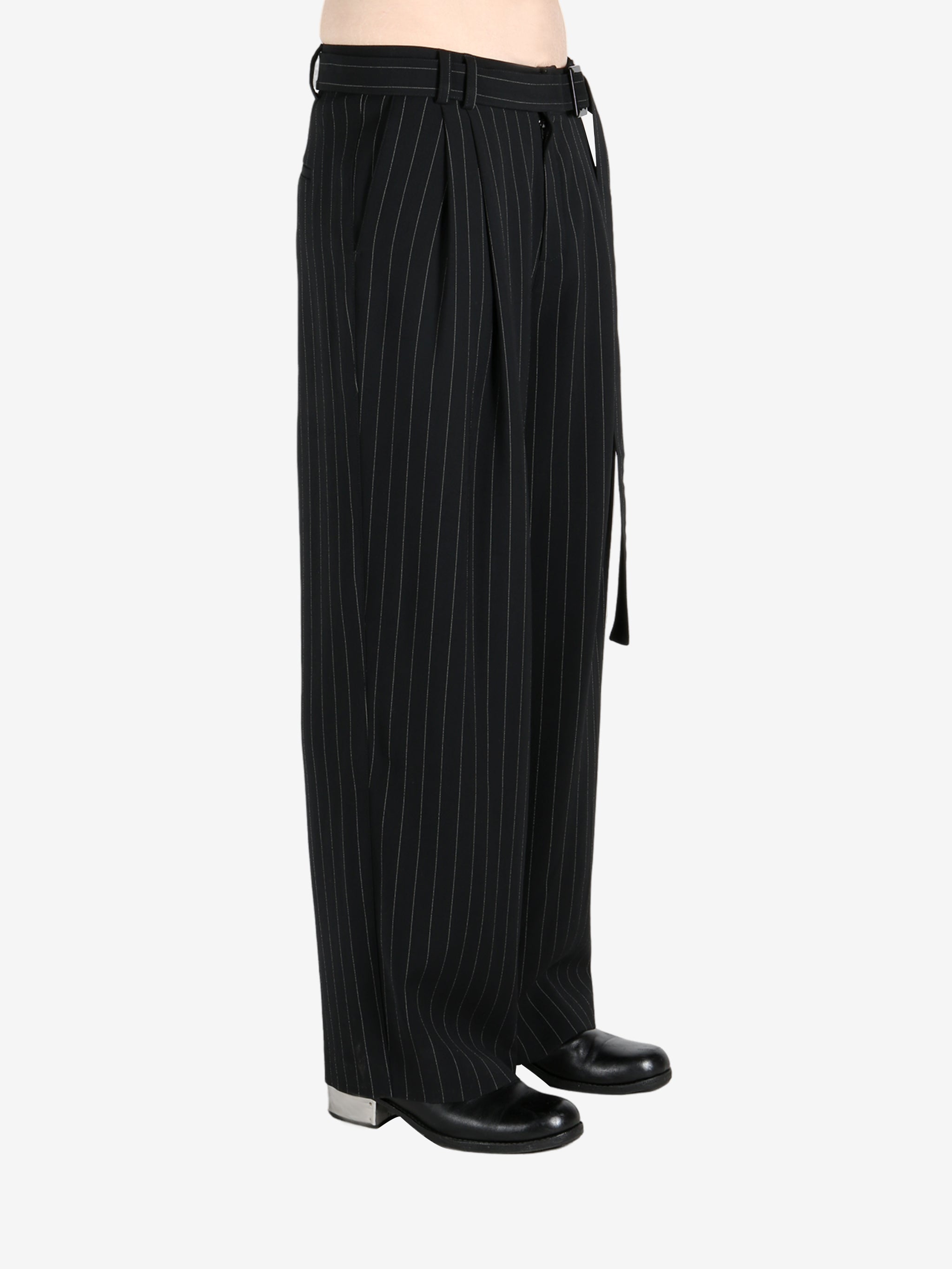 Black pants worn by a person, showing the pants fit