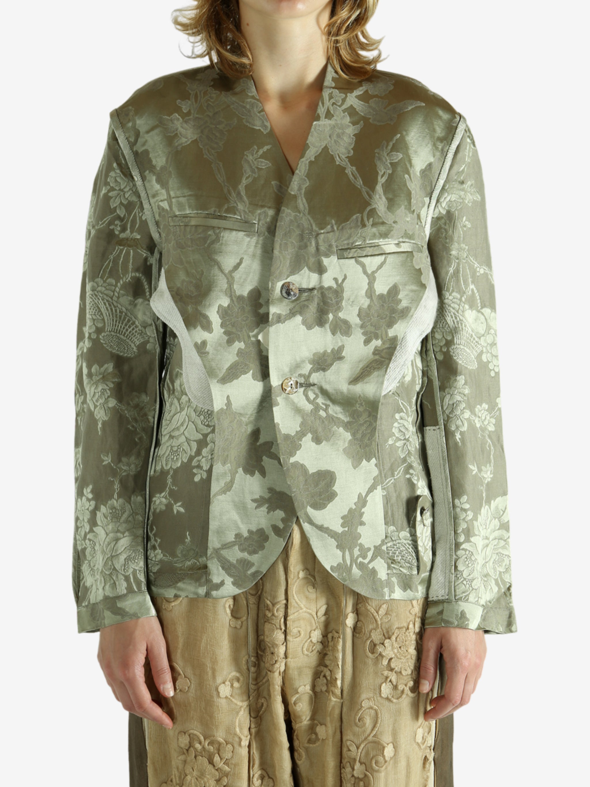 Green jacket worn by a person, showing the jacket fit