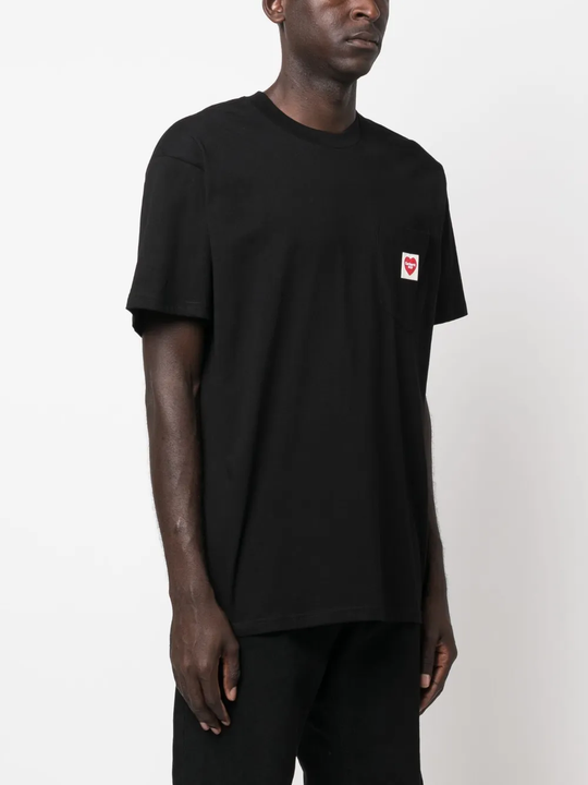 Black t-shirt worn by a person, showing the shirt's fit