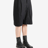 Black shorts worn by a person, showing the shorts's fit