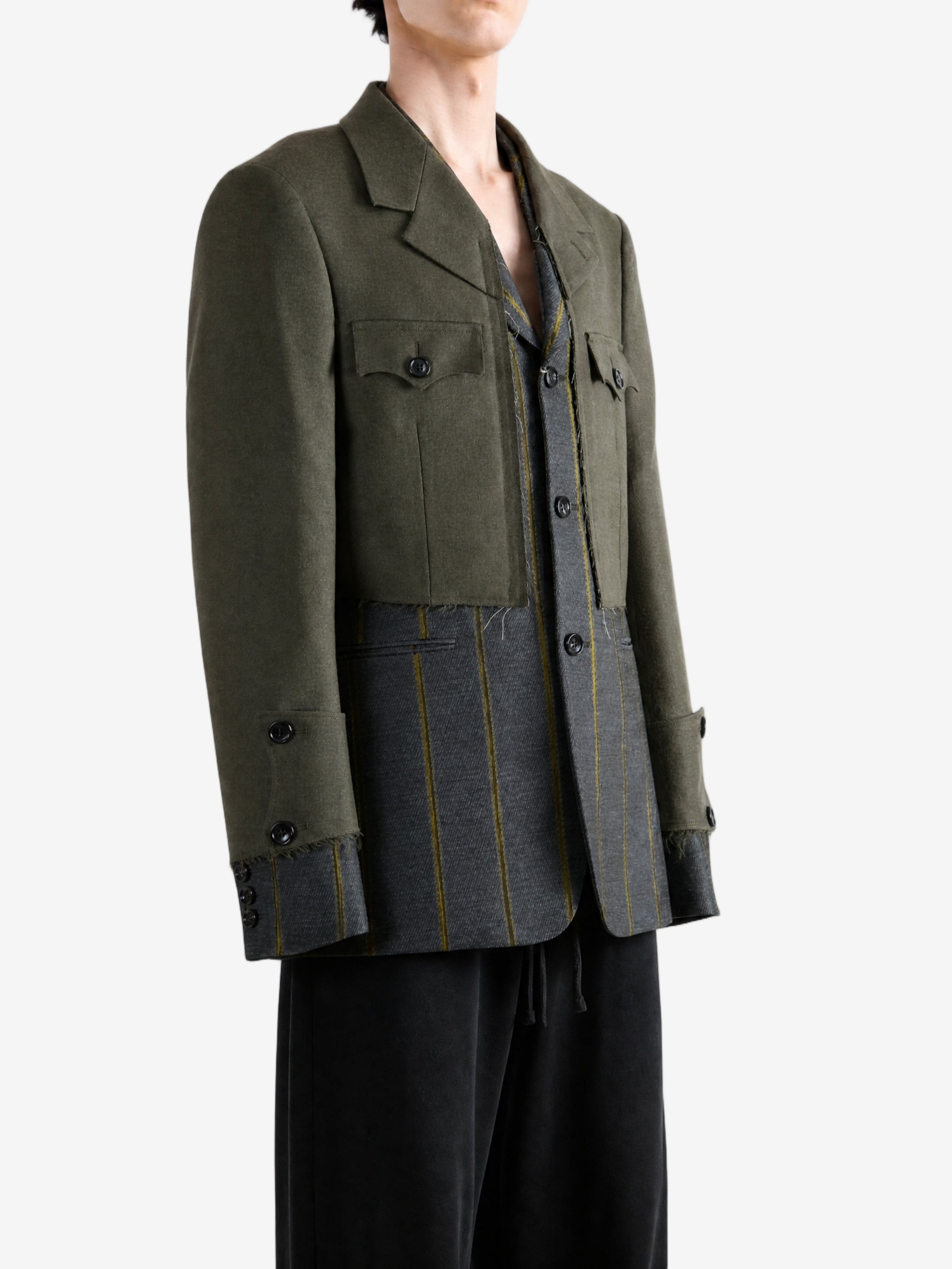 Green jacket worn by a person, showing the jacket fit