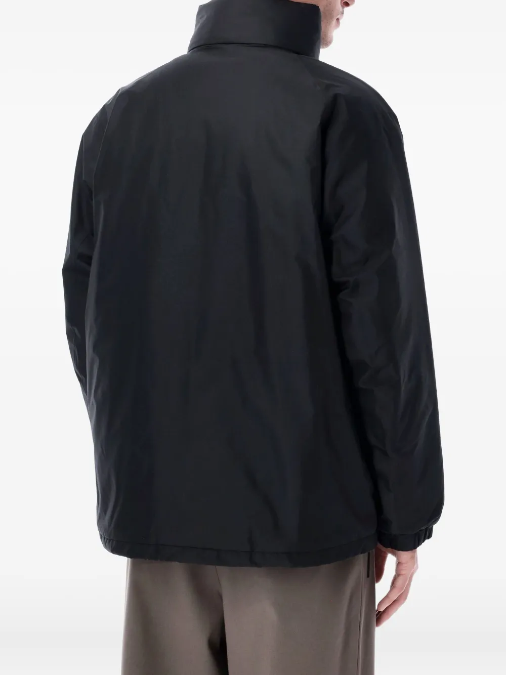 Black jackets worn by a person, showing the jackets fit