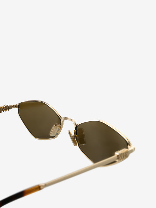 Close up of the green sunglasses, showing texture of the metal fabric