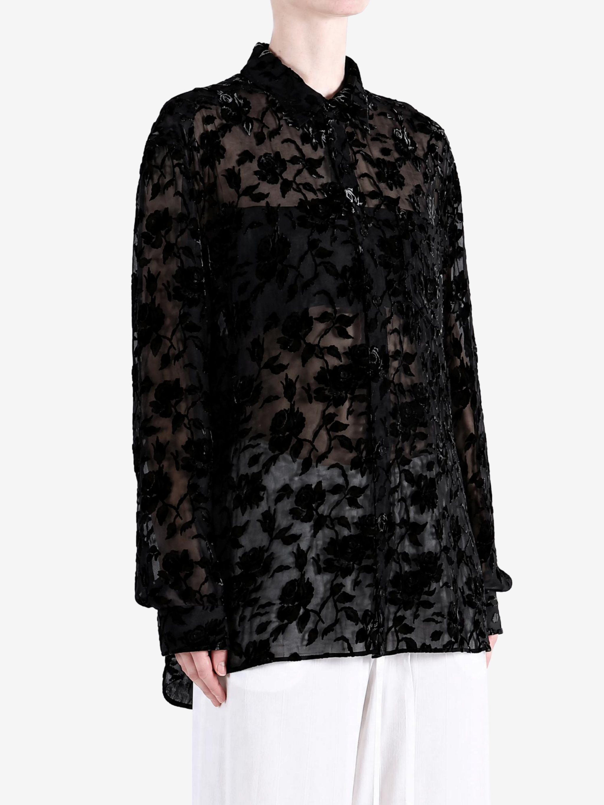 Black shirt worn by a person, showing the shirt fit