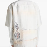 White tops worn by a person, showing the tops fit