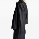 Black tops worn by a person, showing the tops fit