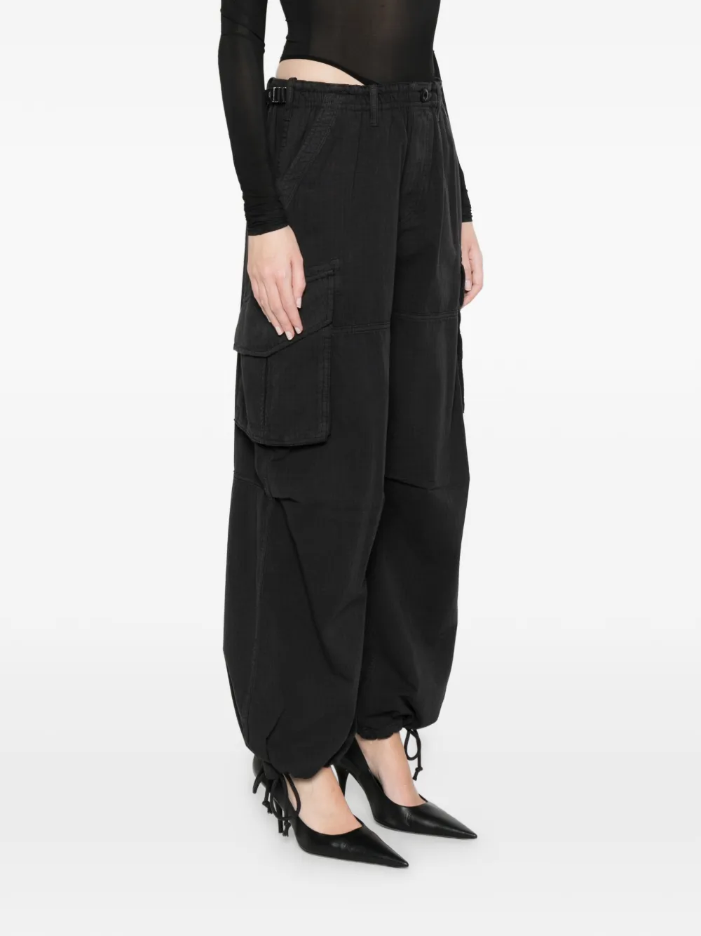 black pants worn by a person, showing the pants fit