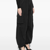 black pants worn by a person, showing the pants fit