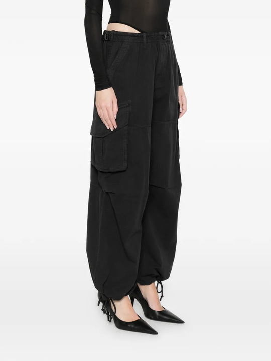 black pants worn by a person, showing the pants fit