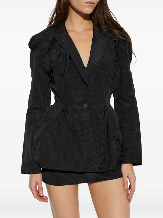 Black jacket worn by a person, showing the jacket fit