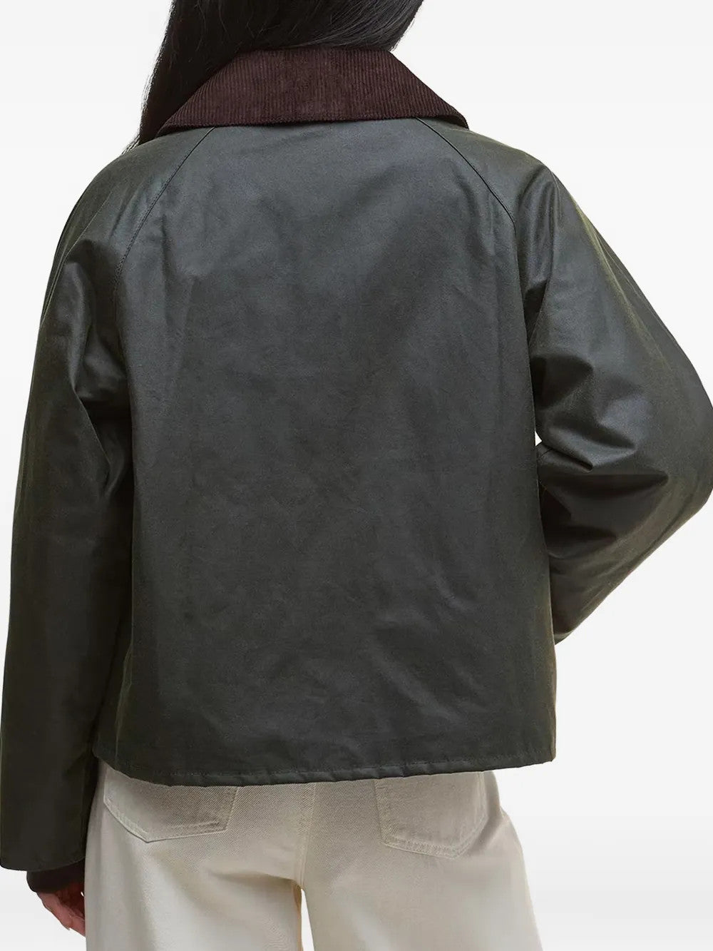 Green jacket worn by a person, showing the jacket fit