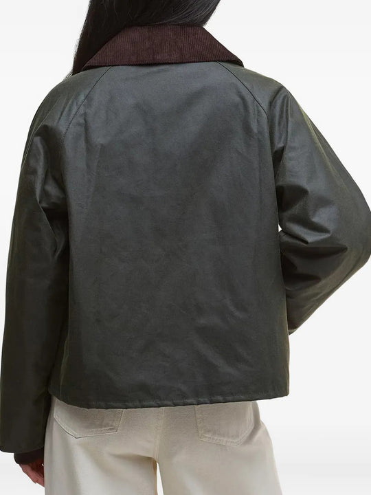 Green jacket worn by a person, showing the jacket fit