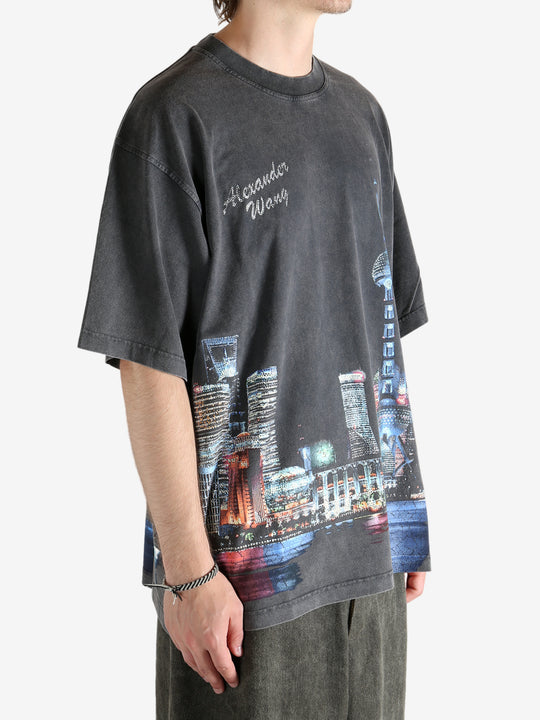 Black shirt worn by a person, showing the shirt fit