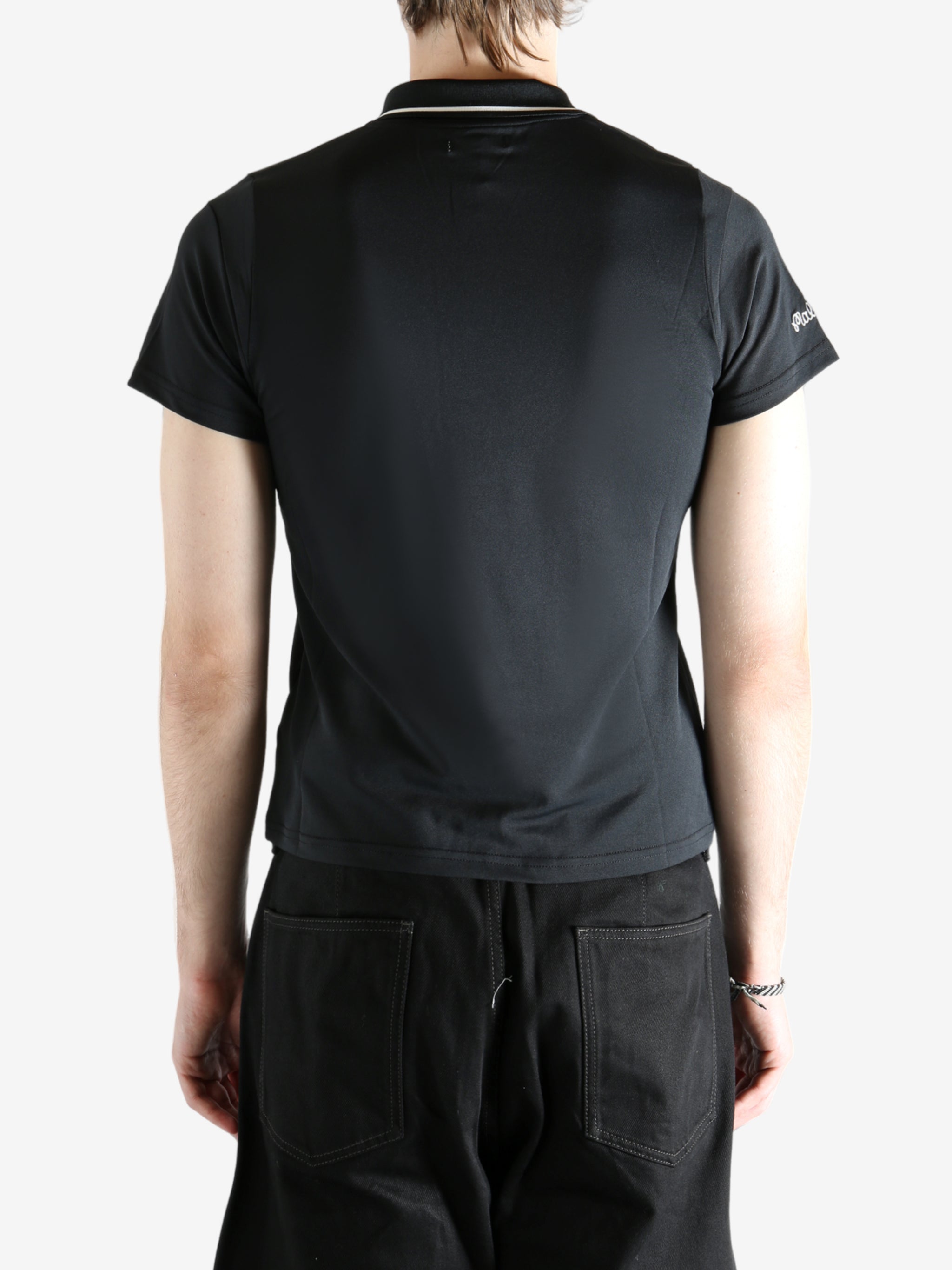 black shirts worn by a person, showing the shirts fit