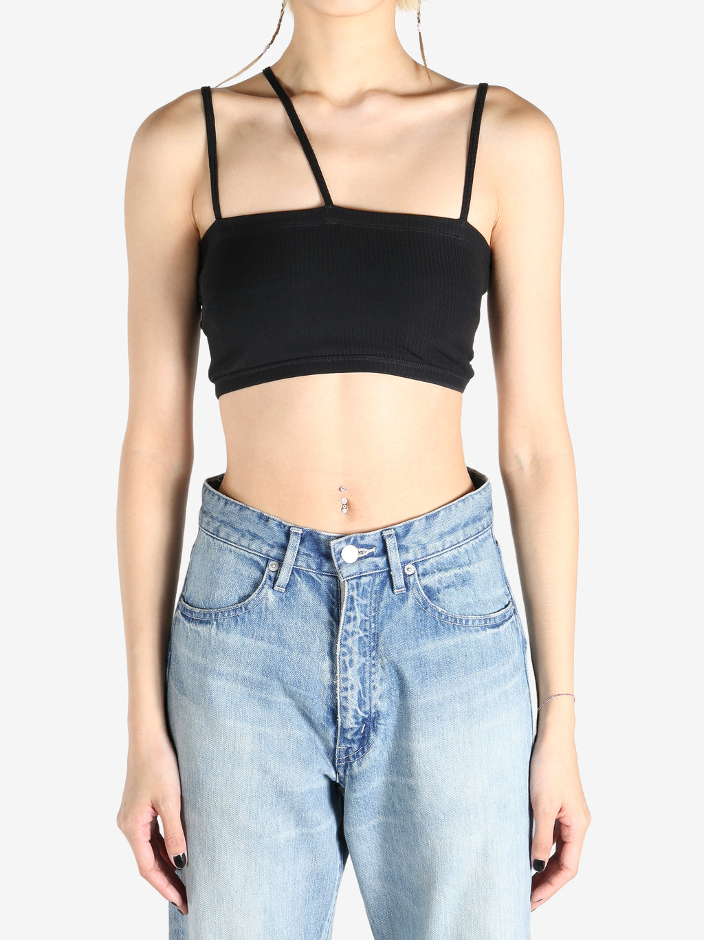 Black tops worn by a person, showing the tops fit