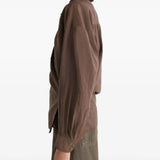 Brown shirt worn by a person, showing the shirt's fit