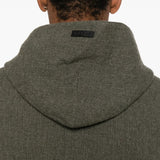 Close up of the black hoodie, showing texture of the wool fabric