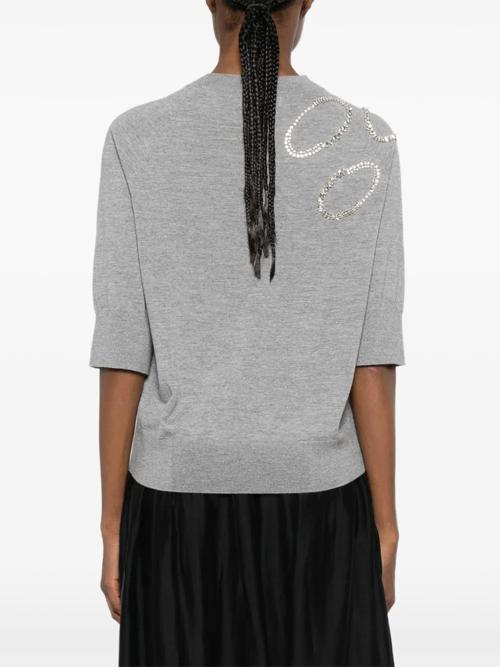 Grey sweater worn by a person, showing the sweater's fit