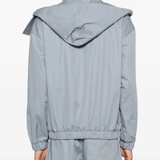 Grey windbreaker worn by a person, showing the windbreaker fit