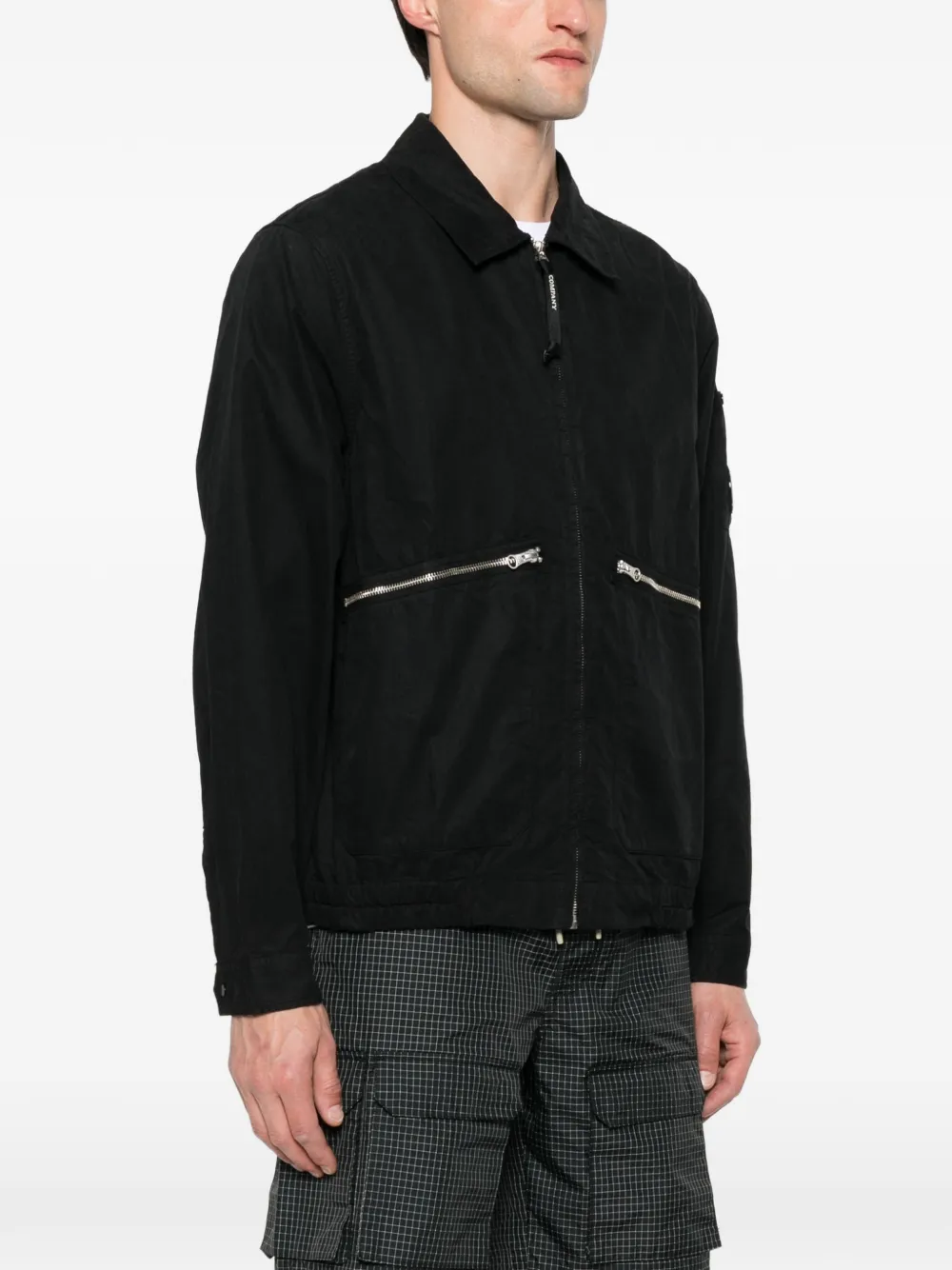 Black coats worn by a person, showing the coats fit