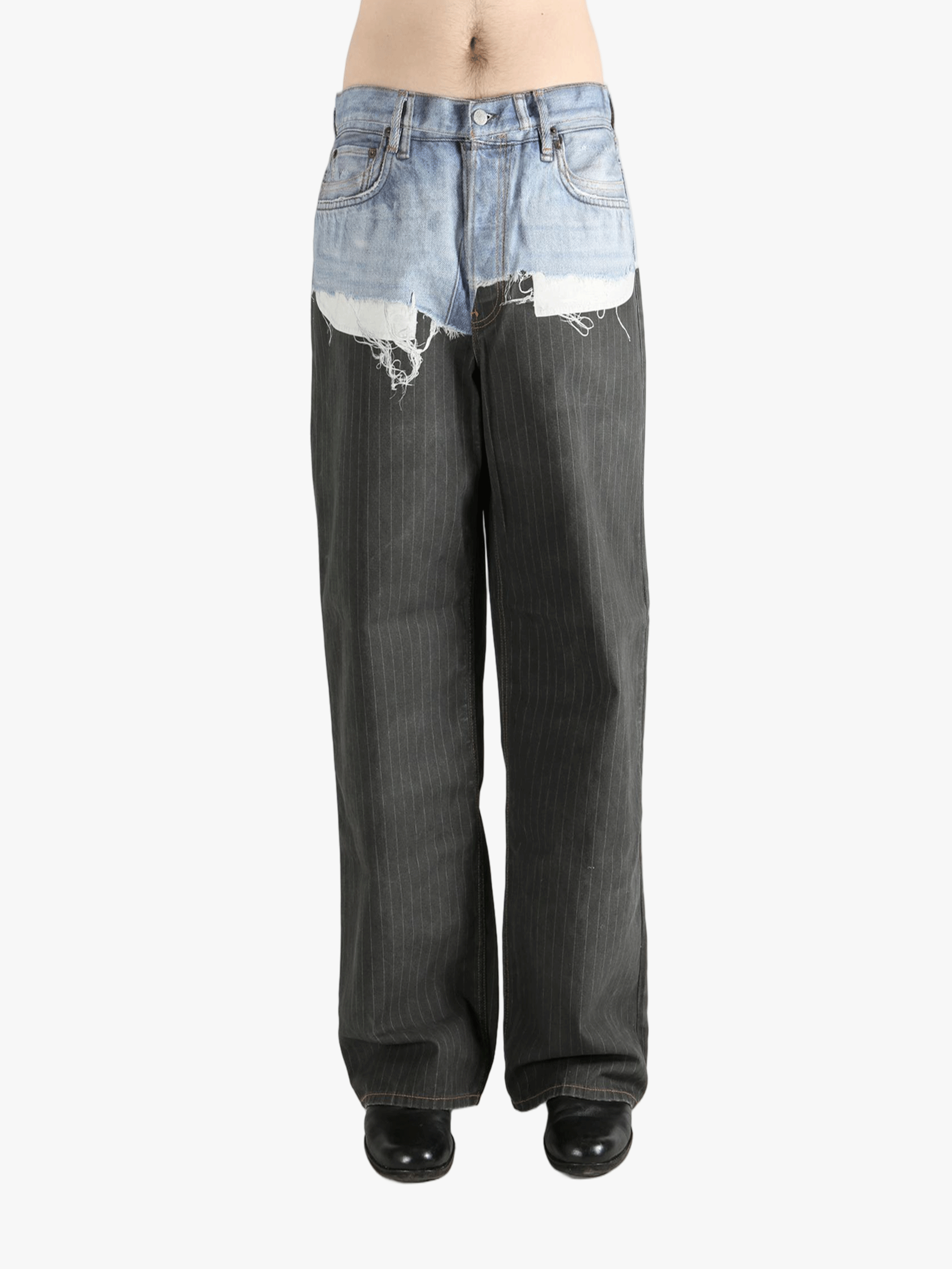 Black jeans worn by a person, showing the jeans fit