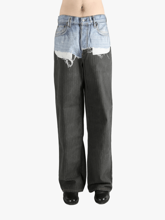 Black jeans worn by a person, showing the jeans fit