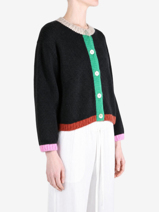 Black knitwear worn by a person, showing the knitwear fit