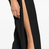 Black pants worn by a person, showing the pants fit