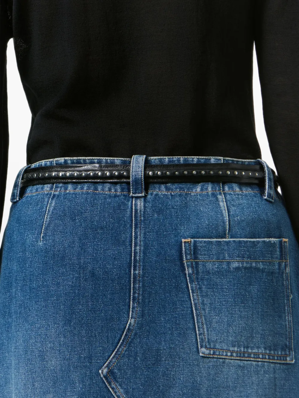 Black accessories worn by a person, showing the accessories fit