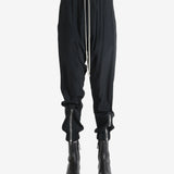 Black pant worn by a person, showing the pant's fit